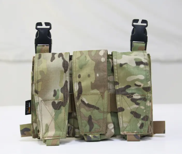 three-cell magazine pouch. Each cell has a flap secured with Velcro, and there are two black buckles at the top for attachment. The pouch is made from Cordura fabric.